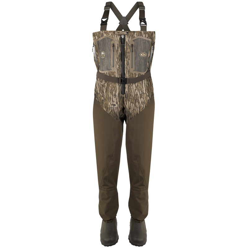 Guardian Elite Front Zip Insulated Wader with sewn-in liner, featuring a camouflage pattern, adjustable straps, front zipper, chest pockets, and built-in boot feet for fly-fishing or hunting.