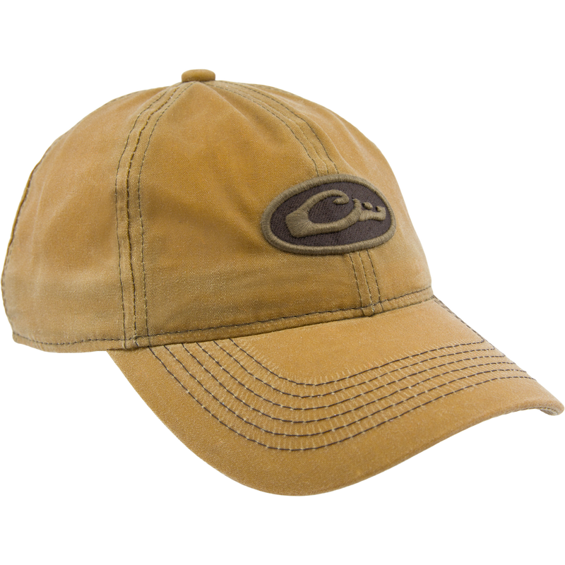 Box Waxed Canvas Cap with mid-profile, six-panel design, featuring an embroidered Drake logo patch and adjustable brass slide closure, displayed on a mannequin head.