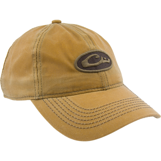 Box Waxed Canvas Cap with mid-profile, six-panel design, featuring an embroidered Drake logo patch and adjustable brass slide closure, displayed on a mannequin head.
