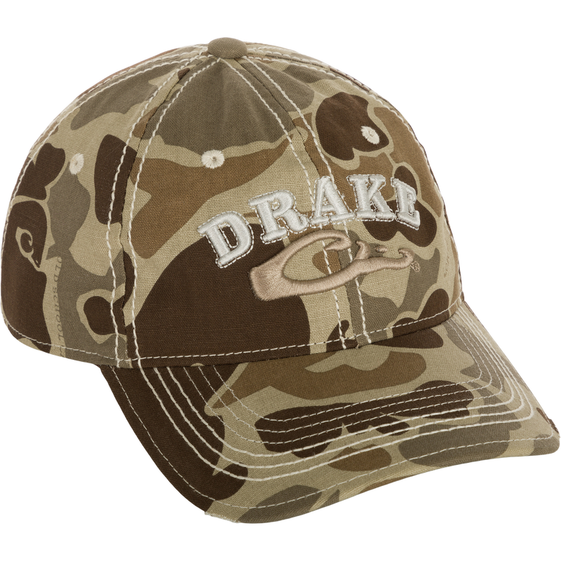 Distressed 6-Panel Ball Cap with raised Drake Logo embroidery, frayed visor, and contrast stitching. Cotton twill panels and adjustable closure.