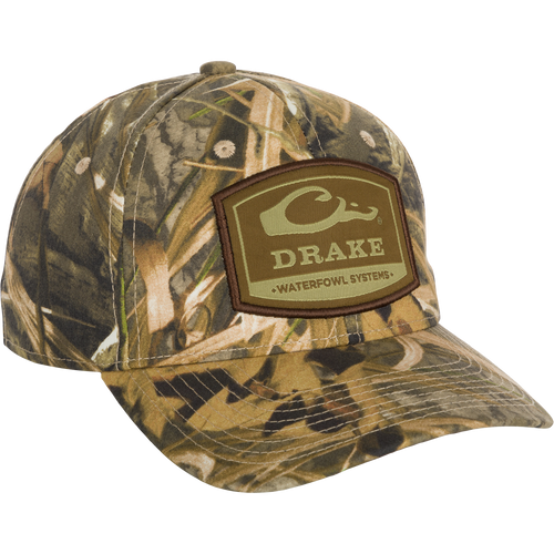 6-Panel Badge Cap: A close-up of a hat with a patch and logo. Classic design with a secure fit. Perfect for outdoor enthusiasts.