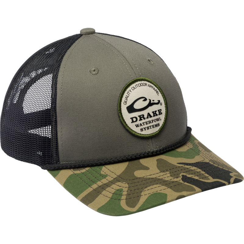 Drake Circle Badge Rope Cap with mesh back, featuring a logo patch, structured crown, flat bill, and adjustable snap-back, ideal for outdoor enthusiasts.
