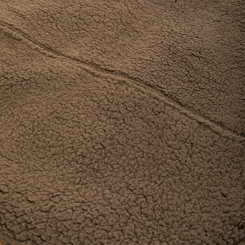 Close-up of the Midweight Nova Silencer Vest's brown Sherpa fleece, highlighting its seam and soft texture, designed for warmth and breathability in outdoor activities.