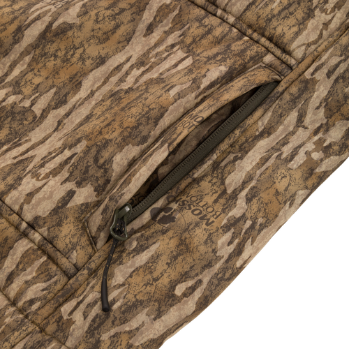 Midweight Nova Silencer Vest with Agion Active X2, showcasing its bottomland camo pattern, Magnattach chest pocket, and durable YKK zipper. Ideal for outdoor enthusiasts.