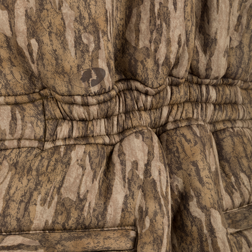 Midweight Nova Silencer Bib with Scent Control, featuring a quilted camouflage pattern, ruched waist, hanging belt, and logo. Ideal for silent, warm, and water-resistant outdoor adventures.