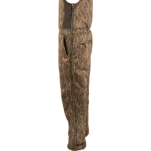 Midweight Nova Silencer Bib with Scent Control, featuring adjustable straps, full-length side zippers, and multiple pockets, designed for warmth and quiet during outdoor hunting.
