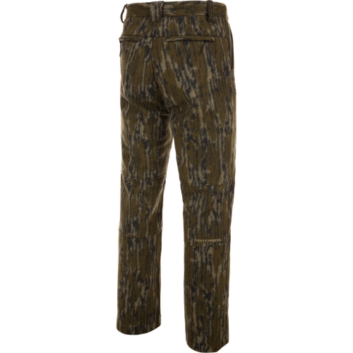 Midweight Hydrowool Softshell Pant with Scent Control features a camouflage design, rear welt pockets, articulated knee seams, and a Non-Typical logo, ideal for outdoor adventures.