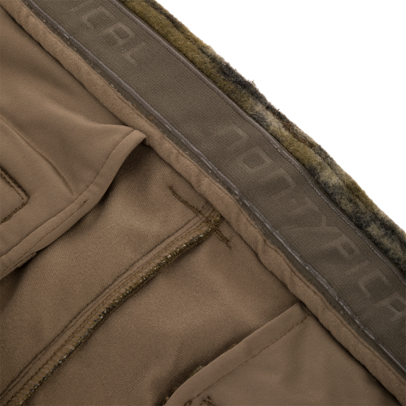 Midweight Hydrowool Softshell Pant with Scent Control, showcasing fleece-lined waistband, elastic stretch, and YKK™ zipper pockets for enhanced comfort and functionality in outdoor adventures.