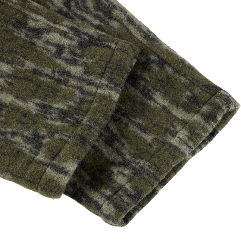 Close-up of the Midweight Hydrowool Softshell Pant’s green-and-black mottled hem, showcasing durable, windproof, waterproof fabric with stretch for outdoor performance.