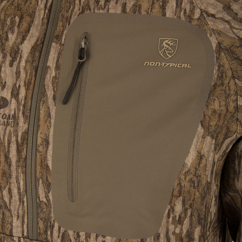 Close-up of the Non-Typical SWT Hybrid Half Zip with Scent Control, showing the camo pattern, logo, and zip chest pocket designed for hunting durability.