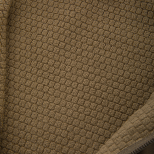 Close-up of tan waffle-textured fleece lining of the Non-Typical SWT Hybrid Half Zip, showcasing breathable fabric and part of a zipper for hunting apparel.