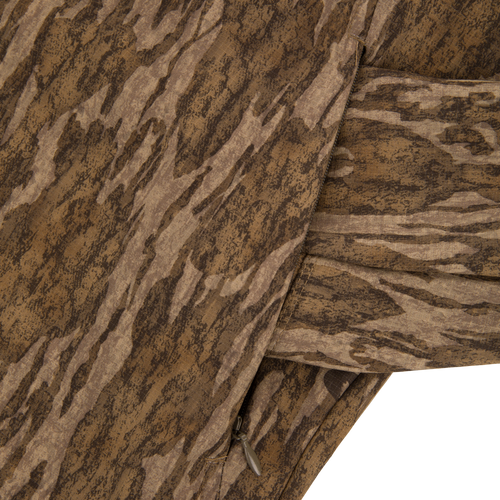 Close-up of the Non-Typical SWT Hybrid Half Zip, highlighting the camouflage fabric and water-resistant zippered pocket, ideal for hunting with scent control technology.