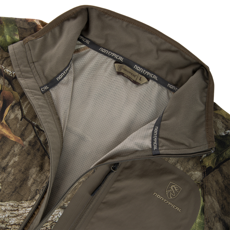 Non-Typical Lightweight SWT Half Zip Pullover with Scent Control, featuring camo-pattern, mesh lining, ergonomic thumbholes, and chest branding, designed for hunting and outdoor activities.