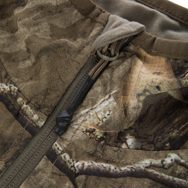 Non-Typical Lightweight SWT Half Zip Pullover with Scent Control, showcasing camo fabric, zippered pocket detail, and paracord pull tab, emphasizing durability and breathability for hunting.