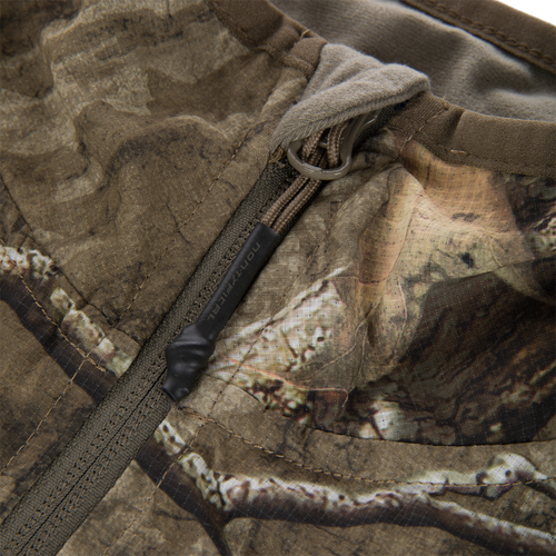Non-Typical Lightweight SWT Half Zip Pullover with Scent Control, showcasing camo fabric, zippered pocket detail, and paracord pull tab, emphasizing durability and breathability for hunting.