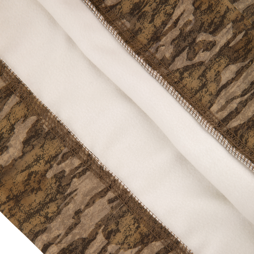 Close-up of the Youth Non-Typical Performance Hoodie with Agion Active, featuring camouflage outer fabric, white fleece lining, and overlock stitching for durability and comfort.
