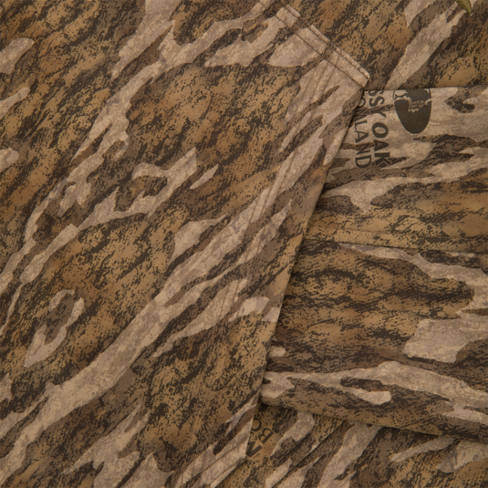 Close-up of Youth Non-Typical Performance Hoodie with Agion Active, showcasing Mossy Oak camo print, seams, and part of the label, emphasizing outdoor durability and flexibility.