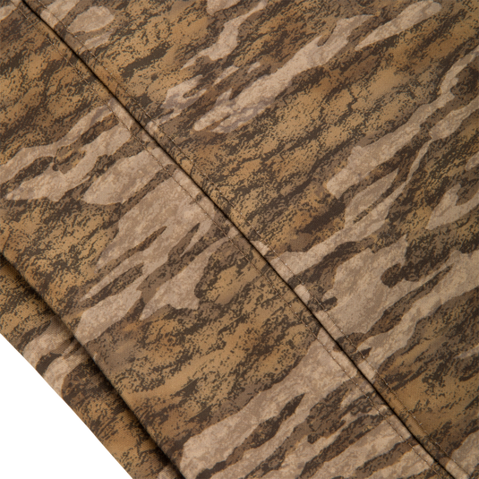 Close-up of the Youth Non-Typical Performance Hoodie with Agion Active, showcasing the camouflage-patterned fabric and diagonal stitched seam, emphasizing its durable, stretchy design for hunting activities.