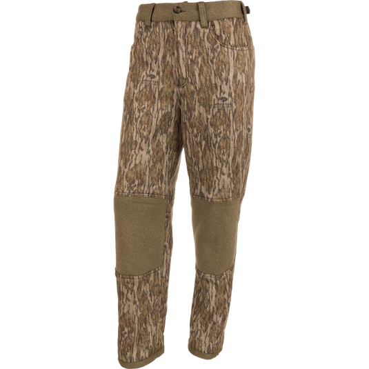 Silencer Soft Shell Pant with Agion Active XL, featuring a camouflage pattern, front and rear pockets, adjustable waist and ankles, and elastic foot stirrups for hunting.