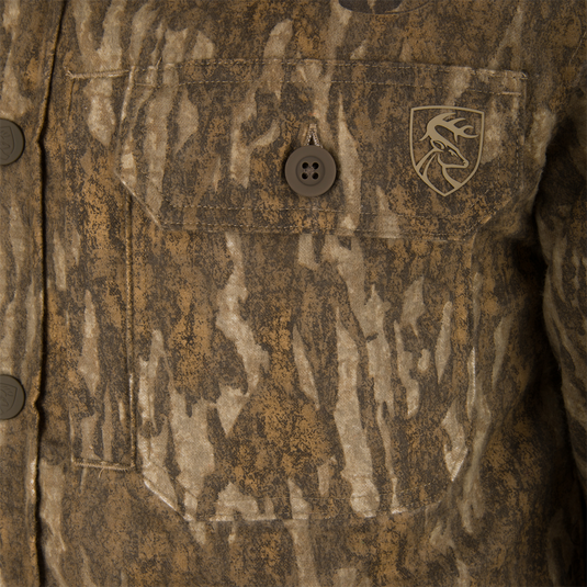 Close-up of the Non-Typical Campfire Hoodie's pocket, featuring a deer-head emblem and buttoned flap, reflecting its functionality and outdoor hunting apparel style.