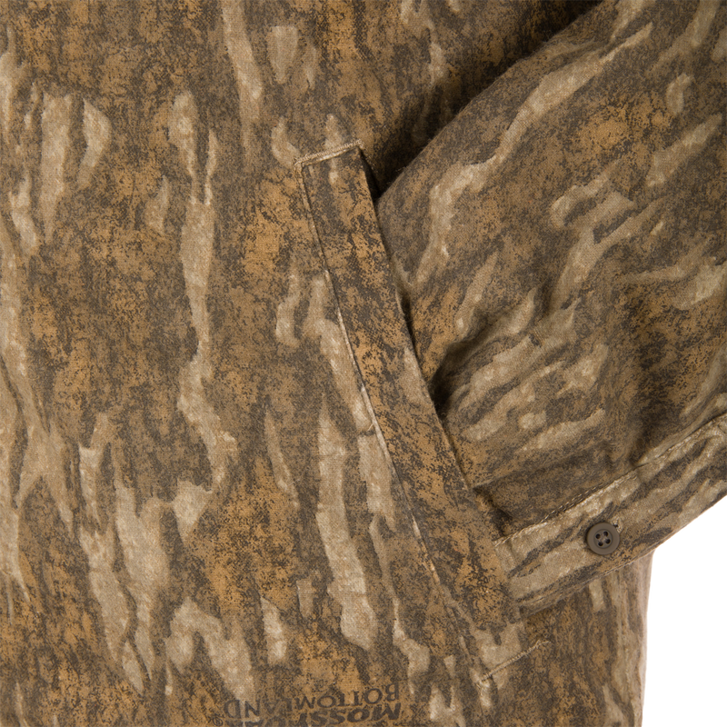 Non-Typical Campfire Hoodie with Mossy Bottom camo print, showcasing a side pocket and buttoned cuff for functionality and warmth in hunting scenarios.