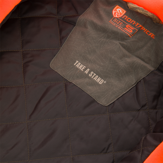 Non-Typical Campfire Hoodie interior features square-pattern quilted insulation and label, highlighting durability and sustainability with cotton-recycled polyester blend, ideal for versatile outdoor use.