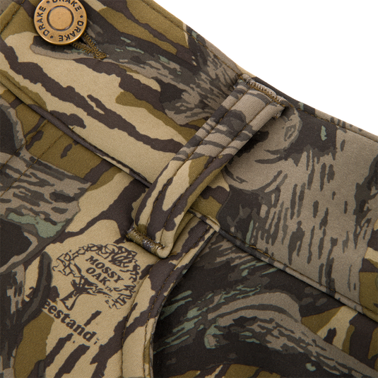 Non-Typical Endurance Pant with Scent Control, featuring camo belt loop, Mossy Oak pattern, Drake snap button, front slash pockets, and adjustable waist for mid-season hunting comfort.