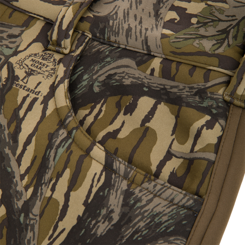Close-up of the Non-Typical Endurance Pant's camo-patterned pocket with Mossy Oak print, showcasing durable stitching and webbing typical of high-quality hunting gear.