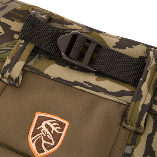 Close-up of the Non-Typical Endurance Pant with Scent Control, featuring a camo waistband, integrated belt, and deer-head logo patch, designed for mid-season hunting.