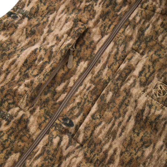 Non-Typical Windproof Layering Vest with zip-front, camouflage-style fleece, featuring a vertical zip pocket, patch pocket, and elastic-banded waist for outdoor protection.