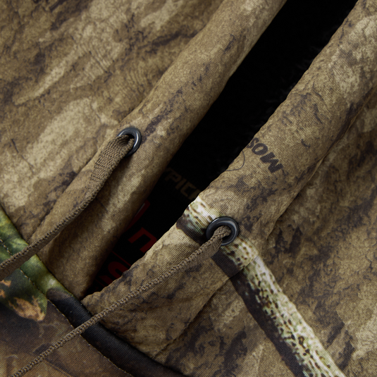 Close-up of Non-Typical Silencer Hoodie with Agion Active X2, showing camouflage-patterned hood, drawcords, eyelets, and detailed interior stitching for hunting performance.