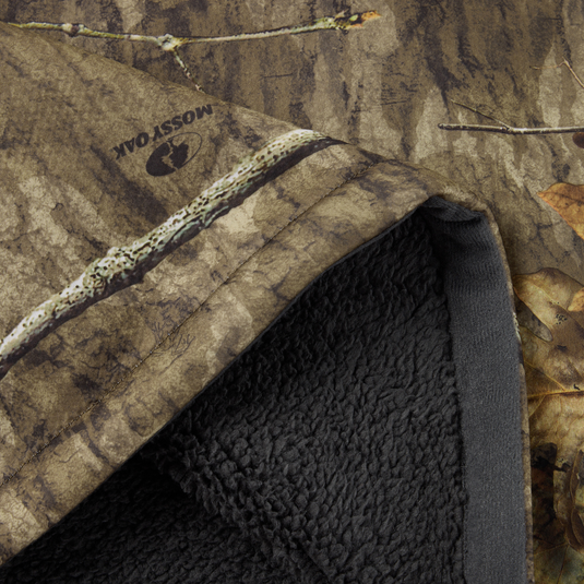 Non-Typical Silencer Hoodie with Agion Active X2, featuring Mossy Oak camo print and black sherpa lining, designed for warmth, breathability, and odor protection.