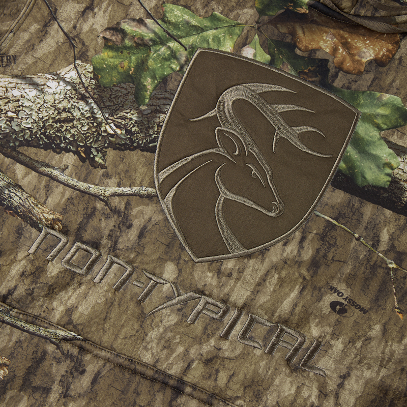 Non-Typical Silencer Hoodie with Agion Active X2 features a camouflage fabric with deer-head embroidery and a Mossy Oak logo, highlighting its hunting-focused design.