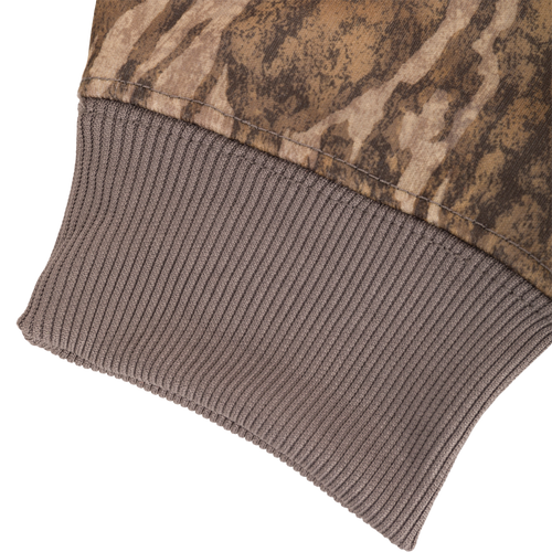 Close-up of Non-Typical Back Eddy Embossed Hoodie fabric, showcasing its durable, water-resistant polyester with a camo-like pattern and stitched detailing.