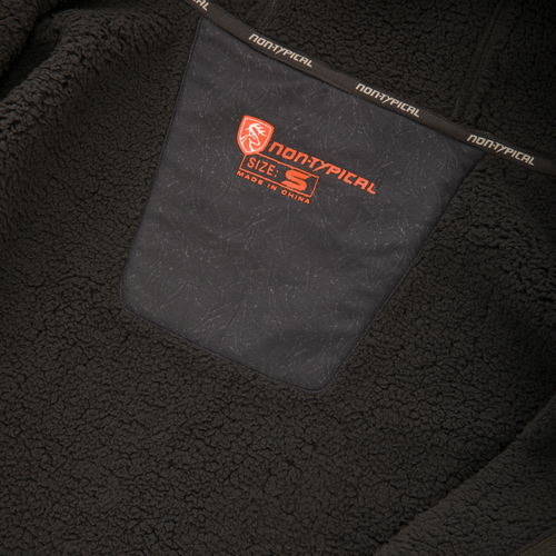 Close-up of the Non-Typical Silencer Full Zip Hoodie's inner chest, showcasing the orange branded nylon pocket panel and neckline trim.