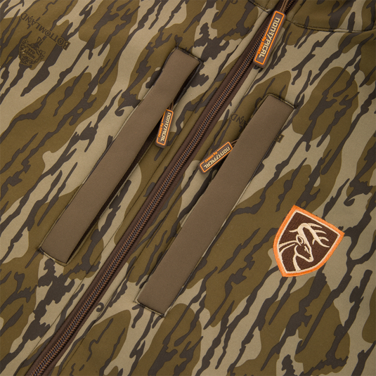 Youth Endurance Full Zip Jacket with Hood features tiger-stripe camo, zippered chest pockets with orange accents, and a deer patch, ideal for focused outdoor activities.