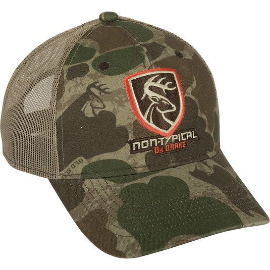 A camouflage hat with the Non-Typical logo on the front, made of 100% cotton twill and breathable mesh on the back. Features a rear hook and loop closure.