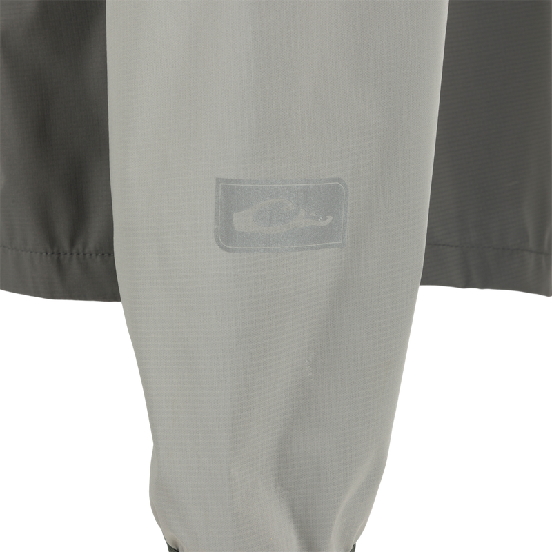 Ultra-Lite Backwaters Waterproof Stretch Jacket close-up, showcasing its lightweight ripstop material and water-resistant zippers, designed for outdoor enthusiasts.