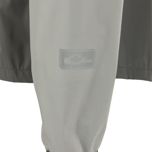 Ultra-Lite Backwaters Waterproof Stretch Jacket close-up, showcasing its lightweight ripstop material and water-resistant zippers, designed for outdoor enthusiasts.