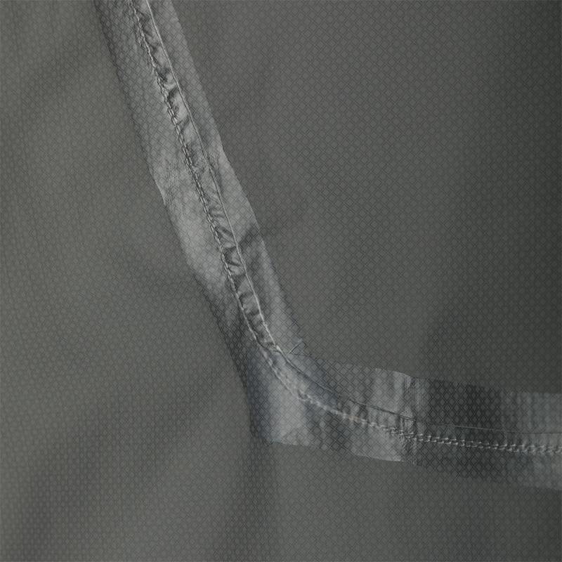 Close-up of the Ultra-Lite Backwaters Waterproof Stretch Jacket's grey fabric, highlighting its 2.5-layer ripstop material, designed for waterproof and breathable performance.