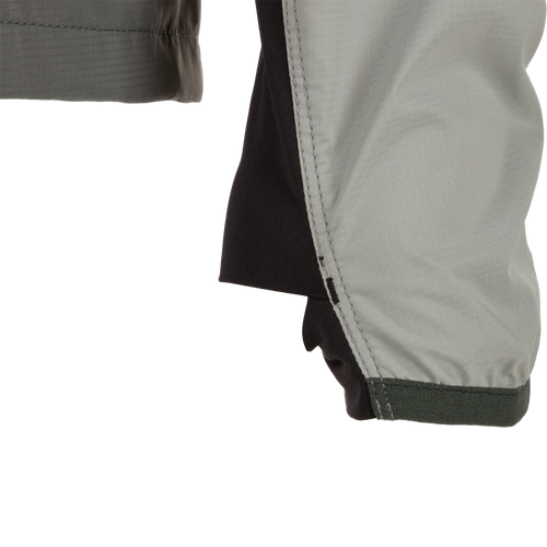 Close-up of the Ultra-Lite Backwaters Waterproof Stretch Jacket sleeve, showcasing its lightweight ripstop fabric and ergonomic design for outdoor enthusiasts.