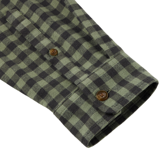 Close-up of the Autumn Flannel Shirt sleeve, highlighting the green-and-black checkered pattern, brown buttons, and brushed cotton twill texture with spandex for flexibility.