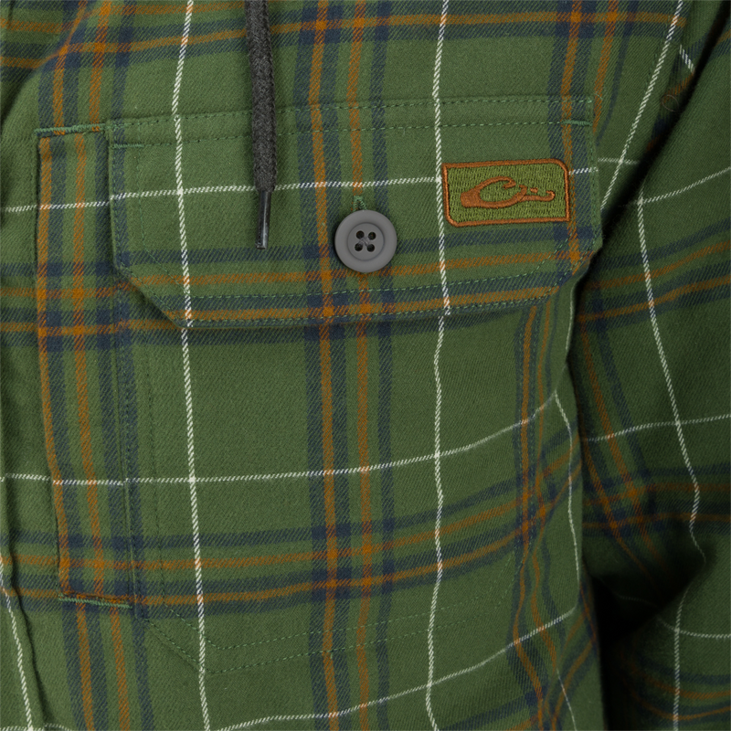 The Campfire Flannel Hoodie features a green plaid pattern with button closures, adjustable hood, and quilted insulation for warmth and comfort.