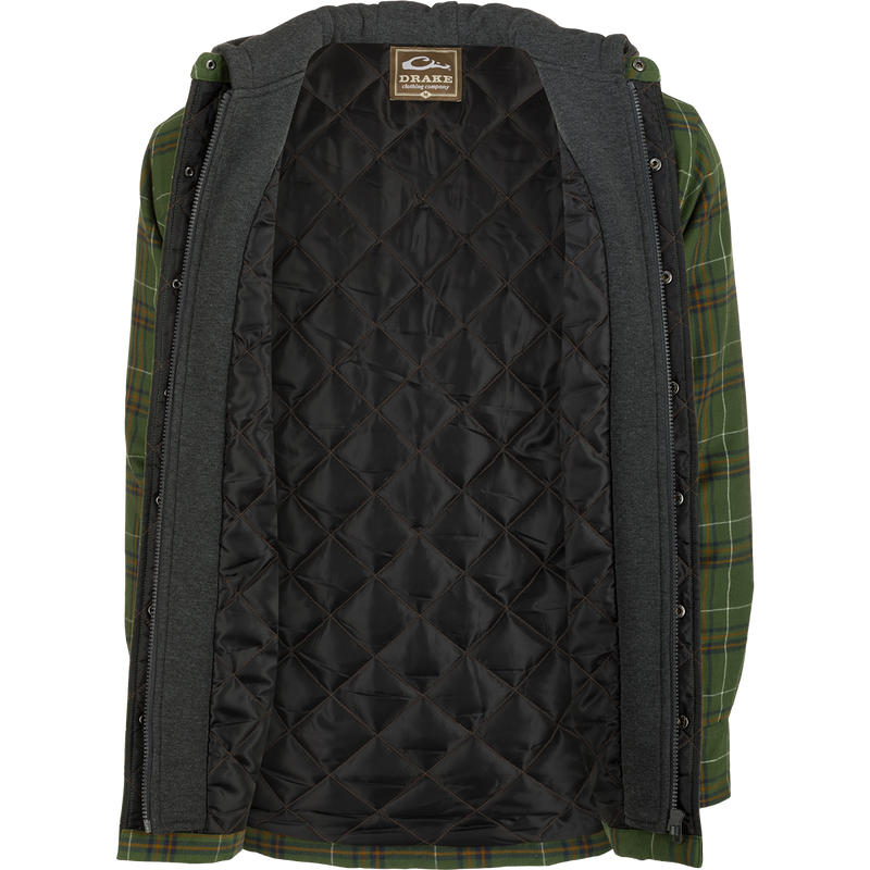 A person wearing the Drake Campfire Flannel Hoodie, a green and black plaid jacket with quilted insulation and an adjustable hood.