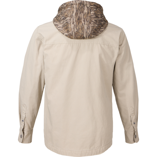 Back view of the Campfire Canvas Shirt Jac Hoodie, featuring a camouflage hood, button-adjustable cuffs, and designed for warmth in outdoor activities.