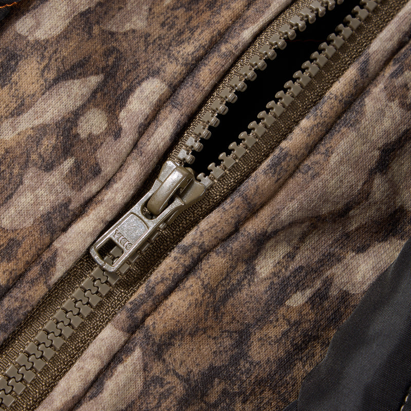 Close-up of YKK zipper on Drake Campfire Canvas Shirt Jac Hoodie, showcasing durable construction ideal for outdoor activities, featuring camouflage fabric for versatile use.