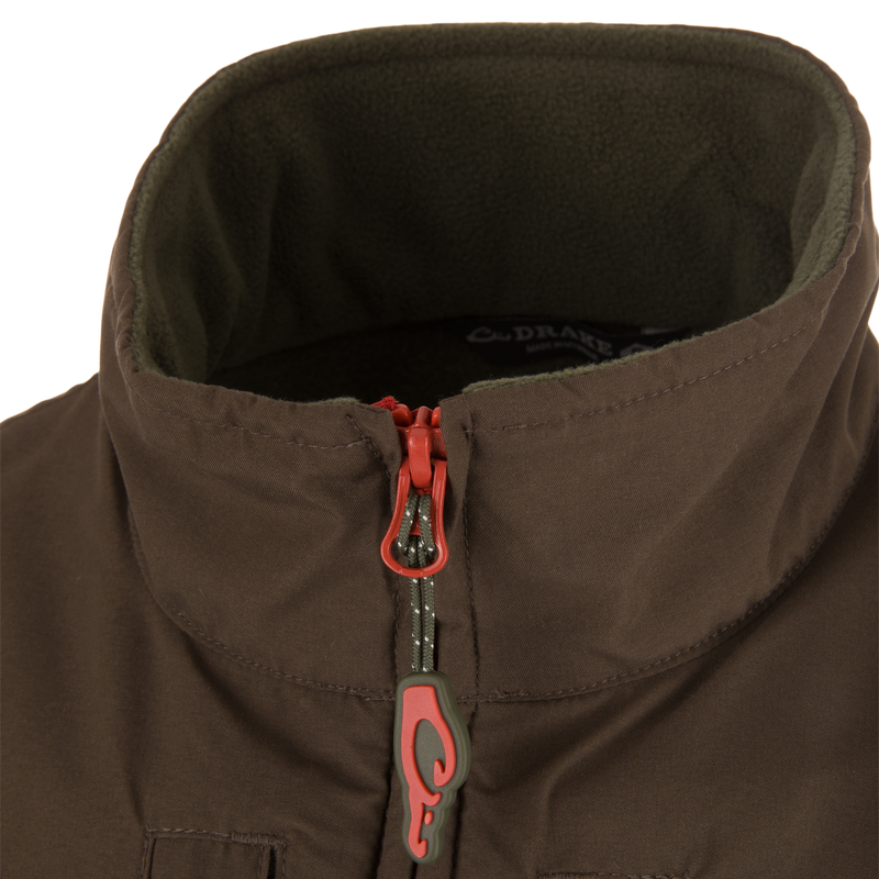 Close-up of the Eqwader Vest's zipper and fabric detailing, showcasing the waterproof upper body and breathable fleece lower section with secure chest pockets.