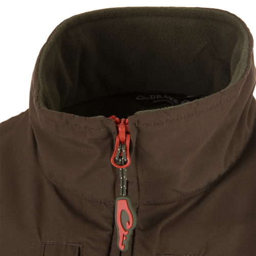 Close-up of the Eqwader Vest's zipper and fabric detailing, showcasing the waterproof upper body and breathable fleece lower section with secure chest pockets.