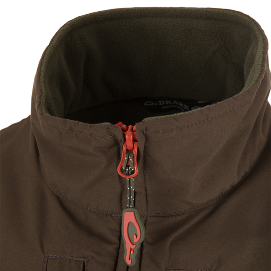 Close-up of the Eqwader Vest's zipper and fabric detailing, showcasing the waterproof upper body and breathable fleece lower section with secure chest pockets.