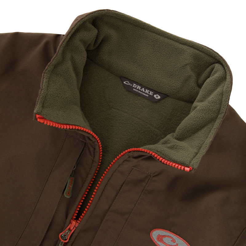 Close-up of the Drake Eqwader Vest, showcasing its waterproof upper body, fleece lower torso, and secure chest pockets for storing valuables.